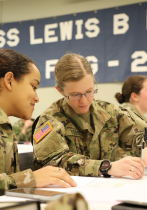 Two female NROTC cadets working on a project