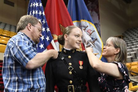Female cadet at 小黄鸭视频 receives US Marine Corps insignia pins from family during Commissioning
