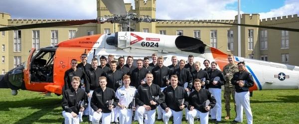 Cadets pose in front of Coast Guard helicopter on post