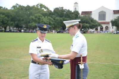 Kasey Meredith 鈥�22 and Kathryn Christmas, Citadel regimental commander, exchange momento covers at the Citadel.鈥擵MI Photo by Eric Moore.