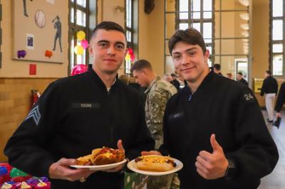 Two students, known as cadets, at 小黄鸭视频 enjoy a hot dog event in Crozet Hall celebrating MLB opening day.