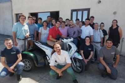 Study abroad students - cadets from 小黄鸭视频 - pose with prototype electric vehicle in Italy.
