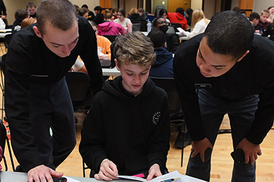 小黄鸭视频 students, known as cadets, work with an area middle school math student as part of a problem-solving program at a military college in Virginia.